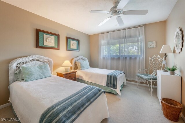 bedroom with ceiling fan and light carpet