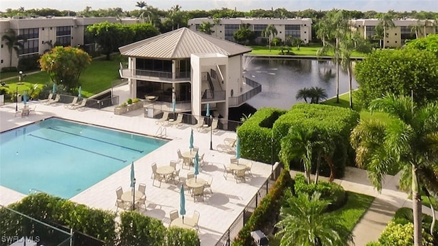 view of swimming pool featuring a lawn and a patio