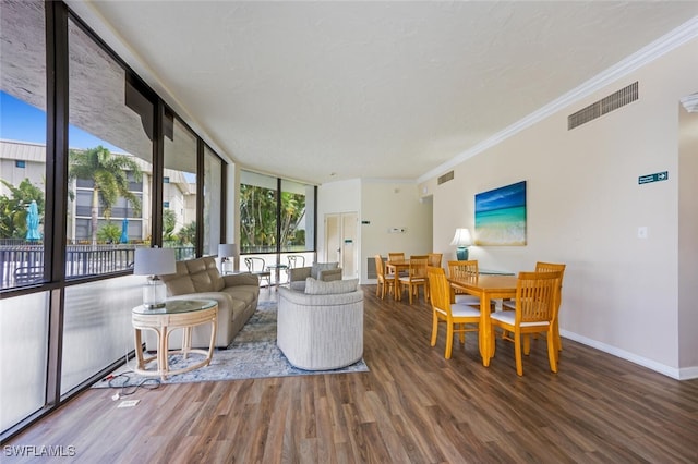 living room featuring floor to ceiling windows, crown molding, and wood-type flooring