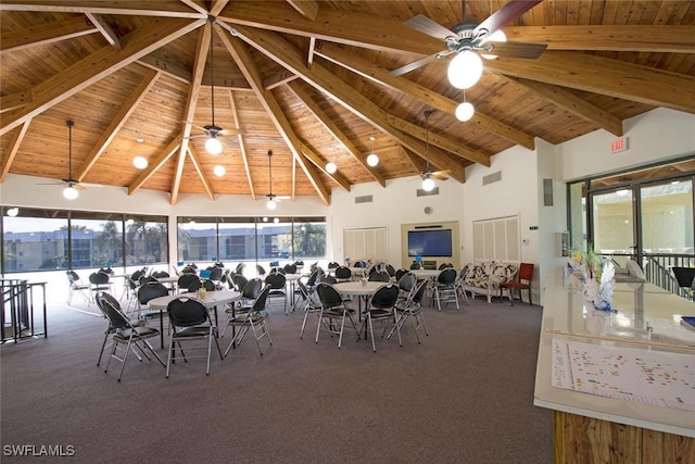 carpeted dining space with wood ceiling, plenty of natural light, ceiling fan, and high vaulted ceiling