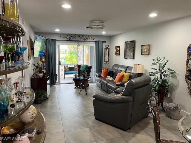 tiled living area featuring recessed lighting