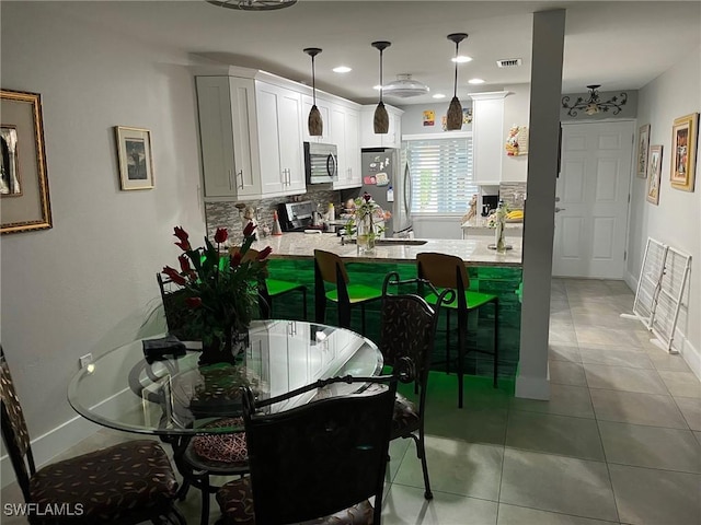 dining room featuring light tile patterned flooring, visible vents, recessed lighting, and baseboards