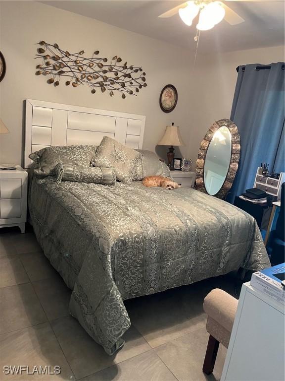 bedroom featuring tile patterned floors and ceiling fan