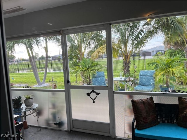 doorway to outside with plenty of natural light and a water view