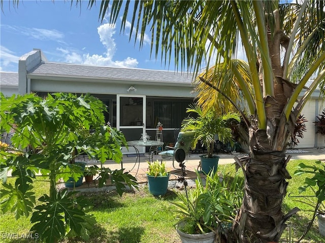 exterior space featuring a sunroom and a patio area