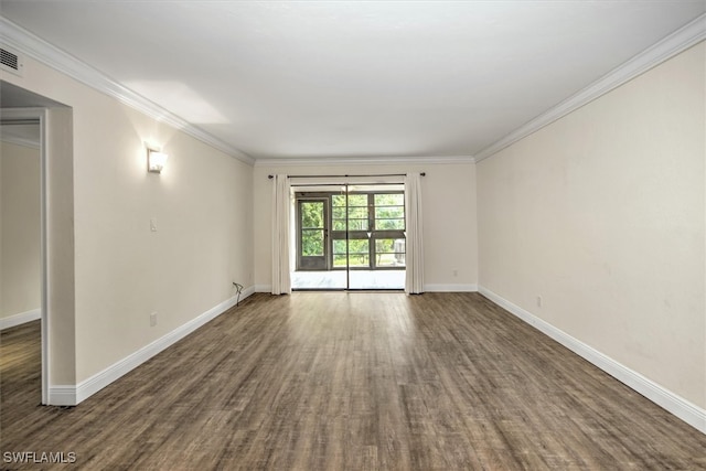 spare room featuring ornamental molding and dark wood-type flooring