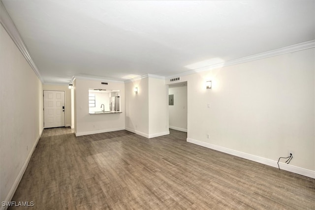 interior space with crown molding, hardwood / wood-style flooring, and sink