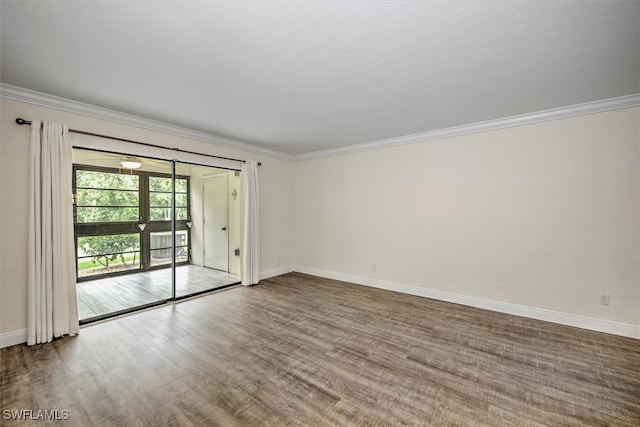 unfurnished room featuring wood-type flooring and ornamental molding