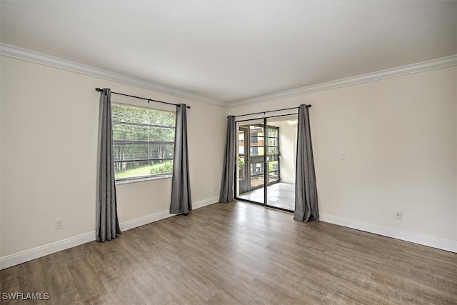 empty room featuring hardwood / wood-style flooring and ornamental molding