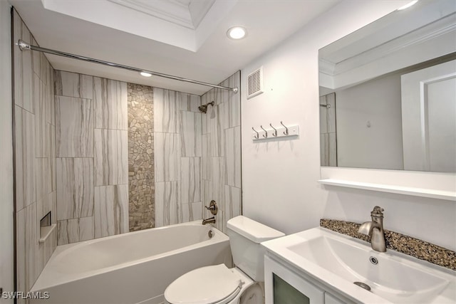 full bathroom with tiled shower / bath, vanity, and toilet