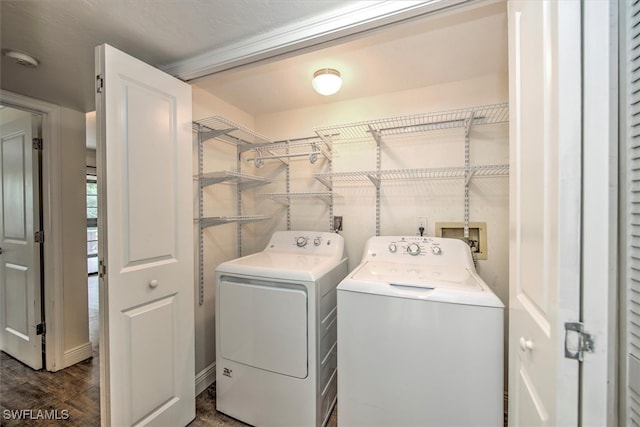 laundry room with washing machine and dryer and dark hardwood / wood-style flooring