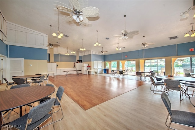 interior space with ceiling fan and light hardwood / wood-style flooring