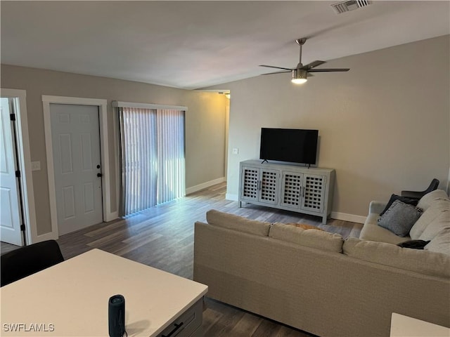 living room with dark hardwood / wood-style floors and ceiling fan