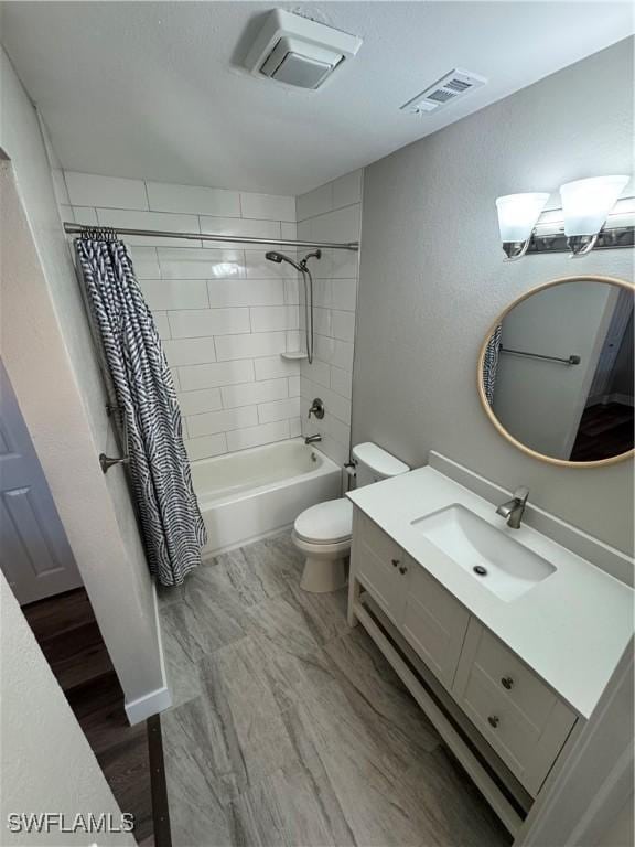 full bathroom featuring shower / tub combo with curtain, vanity, hardwood / wood-style floors, and toilet