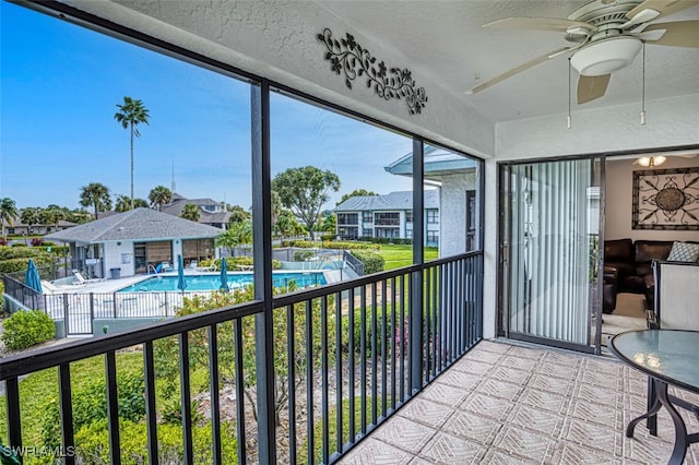 unfurnished sunroom featuring ceiling fan