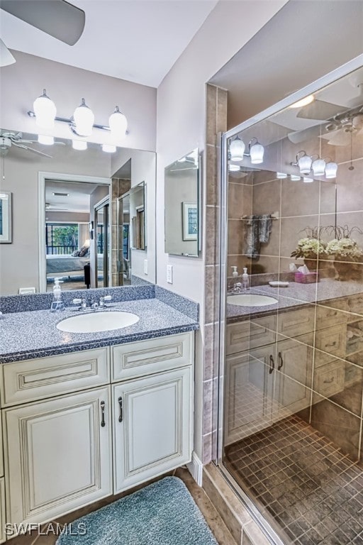 bathroom featuring vanity and an enclosed shower