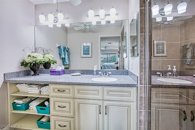 bathroom featuring ceiling fan, a shower with shower door, and vanity