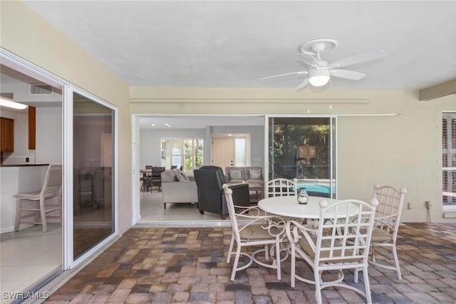 sunroom featuring ceiling fan