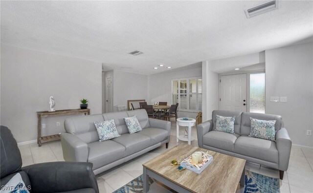 tiled living room with a textured ceiling