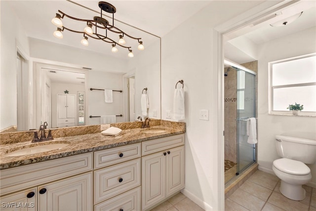 bathroom with vanity, toilet, tile patterned floors, and walk in shower