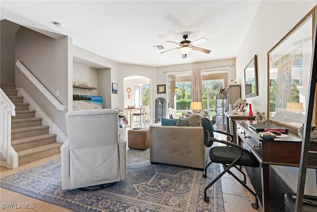 tiled living room featuring ceiling fan