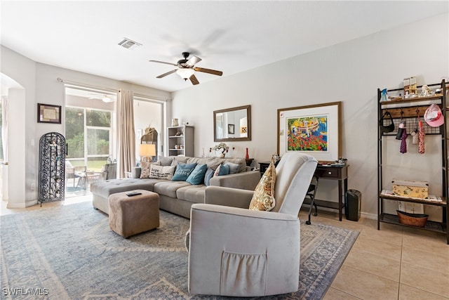 tiled living room with ceiling fan