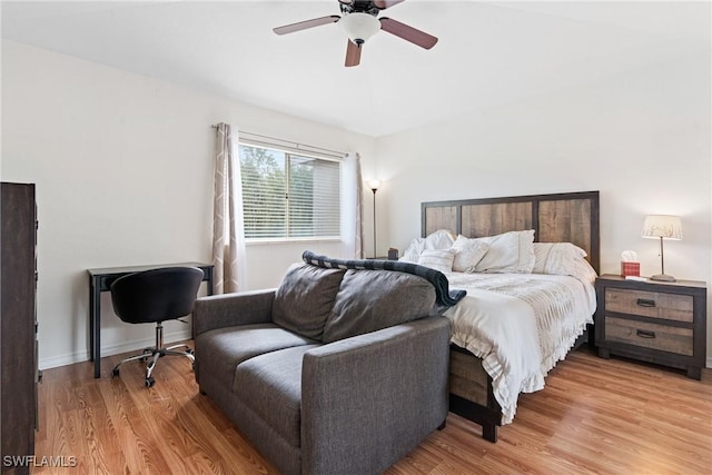 bedroom with baseboards, light wood-style floors, and ceiling fan