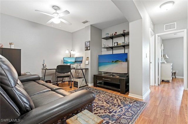 living room with ceiling fan and light hardwood / wood-style floors