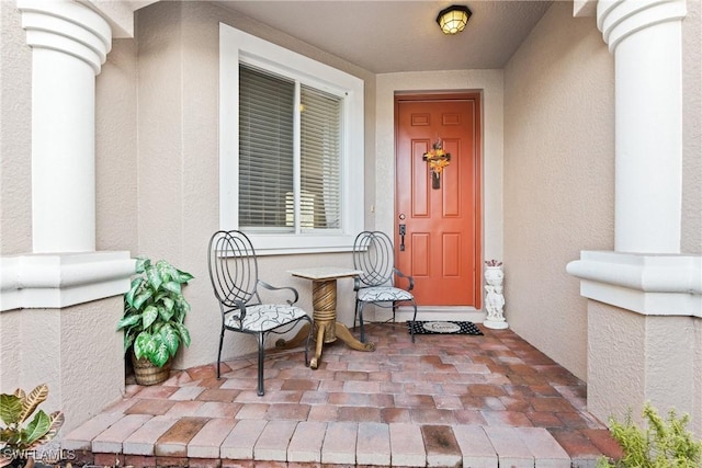 entrance to property with stucco siding