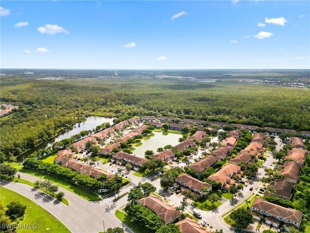aerial view featuring a water view and a view of trees