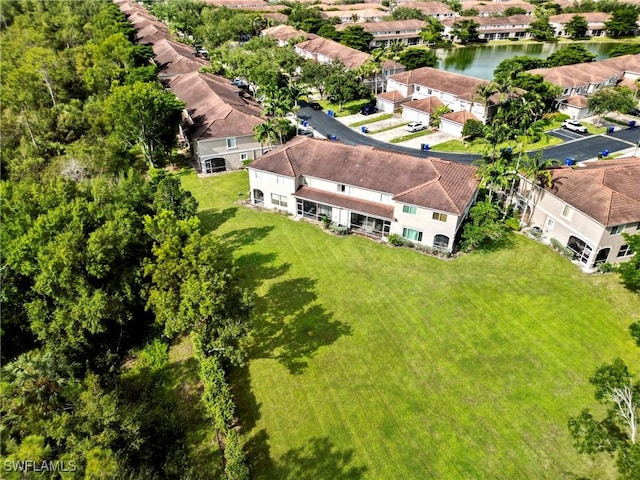 drone / aerial view featuring a residential view and a water view