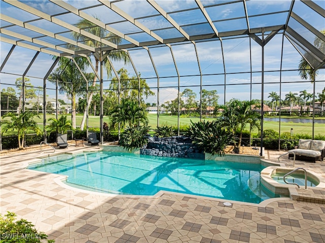 view of pool featuring an in ground hot tub, glass enclosure, and a patio area