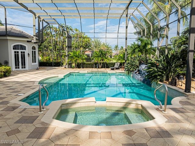 view of pool featuring french doors, glass enclosure, an in ground hot tub, and a patio area