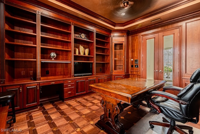 office space with crown molding, wood walls, built in features, and french doors