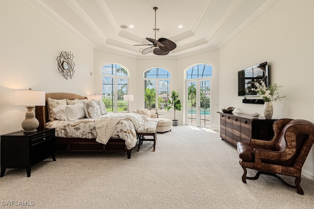 bedroom featuring access to exterior, a tray ceiling, ceiling fan, ornamental molding, and light colored carpet