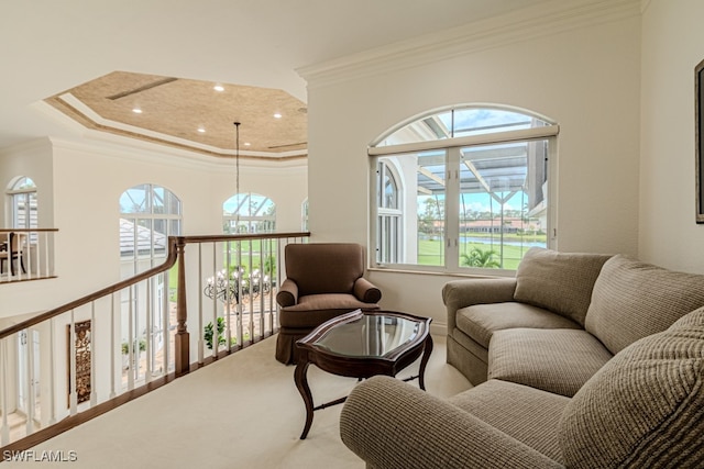 living room with a healthy amount of sunlight, ornamental molding, and a notable chandelier