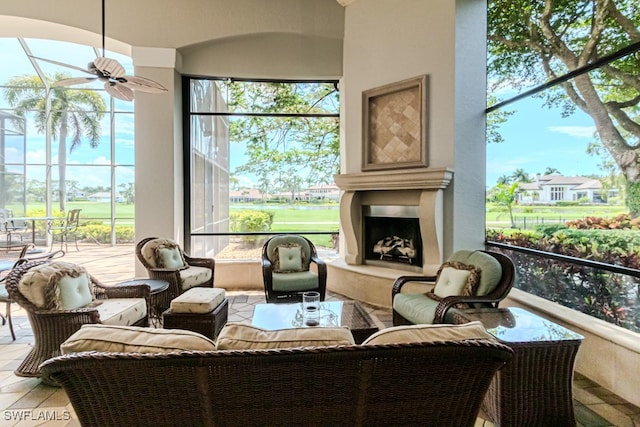 interior space with a premium fireplace and ceiling fan