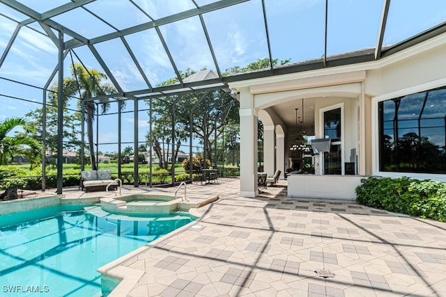 view of pool with a lanai, a patio, and an in ground hot tub