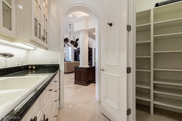 kitchen featuring white cabinetry and sink