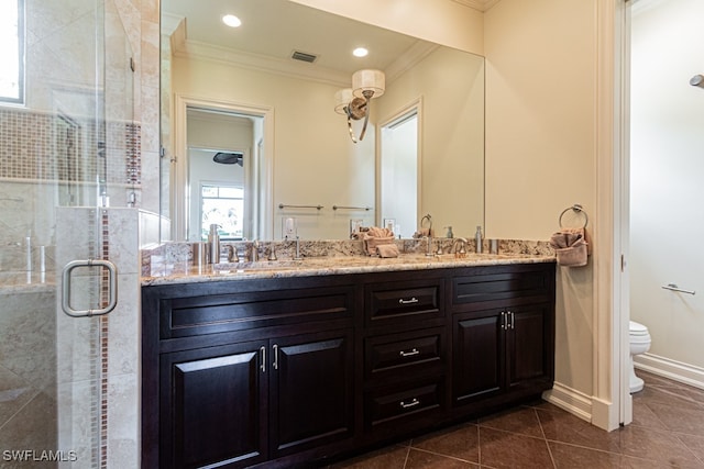 bathroom with vanity, tile patterned flooring, walk in shower, crown molding, and toilet