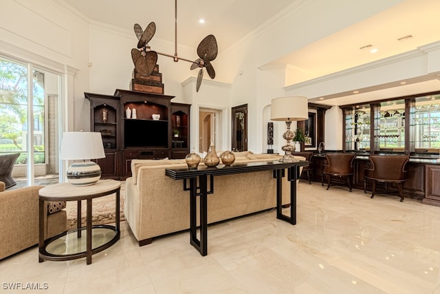 living room with ornamental molding and a high ceiling