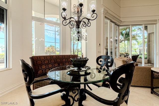 tiled dining space featuring a notable chandelier, a wealth of natural light, and vaulted ceiling