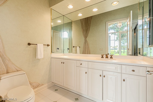 bathroom with tile patterned flooring, vanity, and toilet