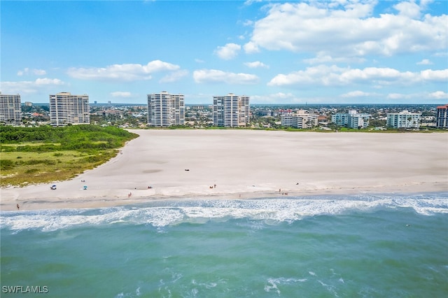 aerial view with a water view and a beach view