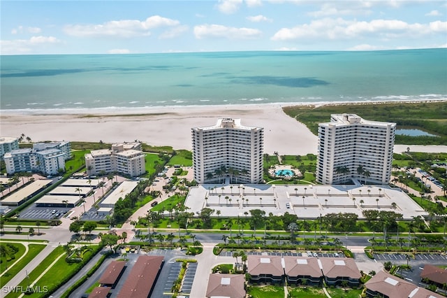 bird's eye view with a water view and a beach view