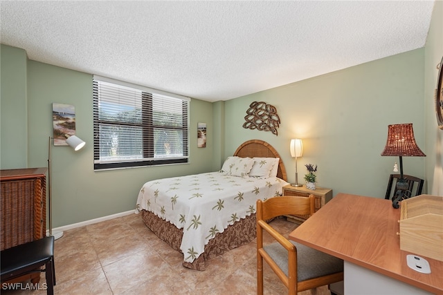 tiled bedroom featuring a textured ceiling