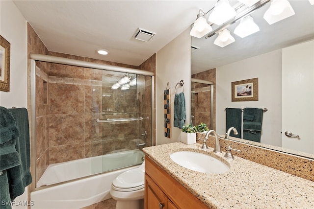 full bathroom featuring bath / shower combo with glass door, vanity, and toilet