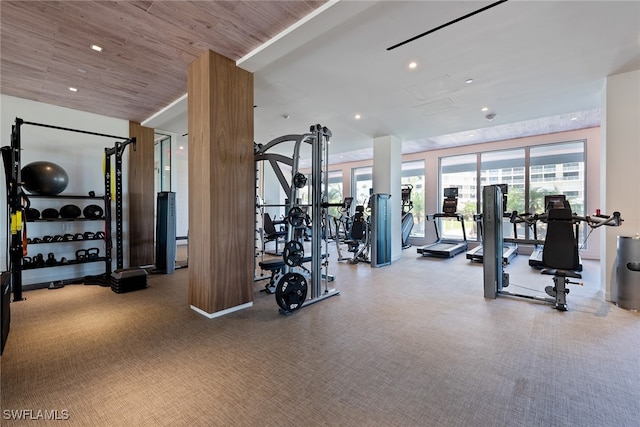 gym featuring carpet and wooden ceiling