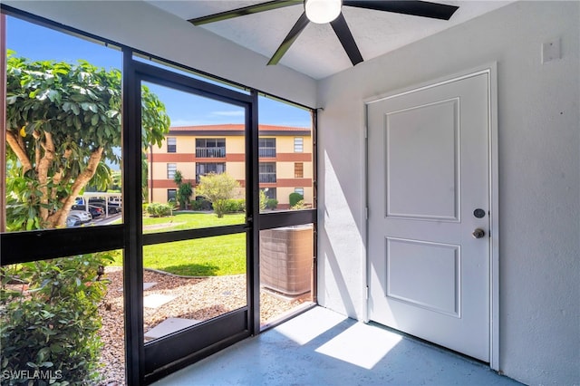 unfurnished sunroom featuring ceiling fan