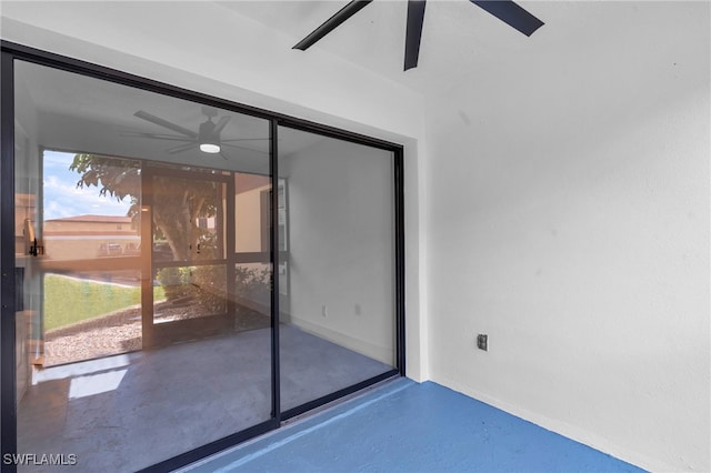 interior space with ceiling fan and concrete flooring